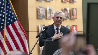Garland speaks with victims' families as new exhibit highlights the faces of gun violence
