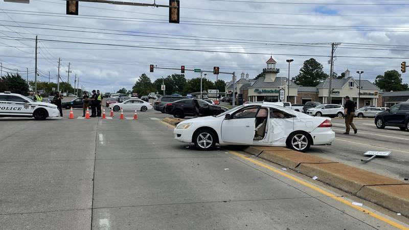 Two cars collided, sending one spinning onto the median where it struck two men soliciting donations.