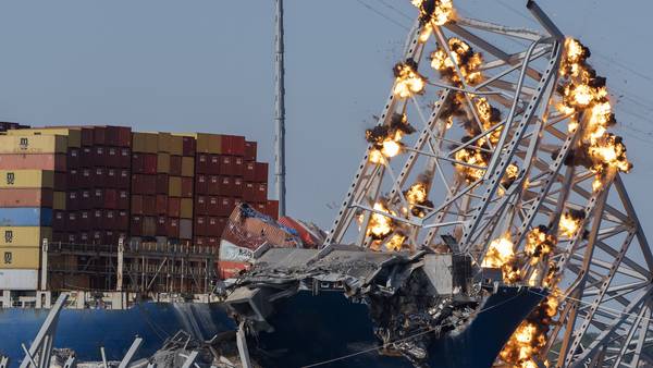 Collapsed Baltimore bridge span comes down with a boom after crews set off chain of explosives