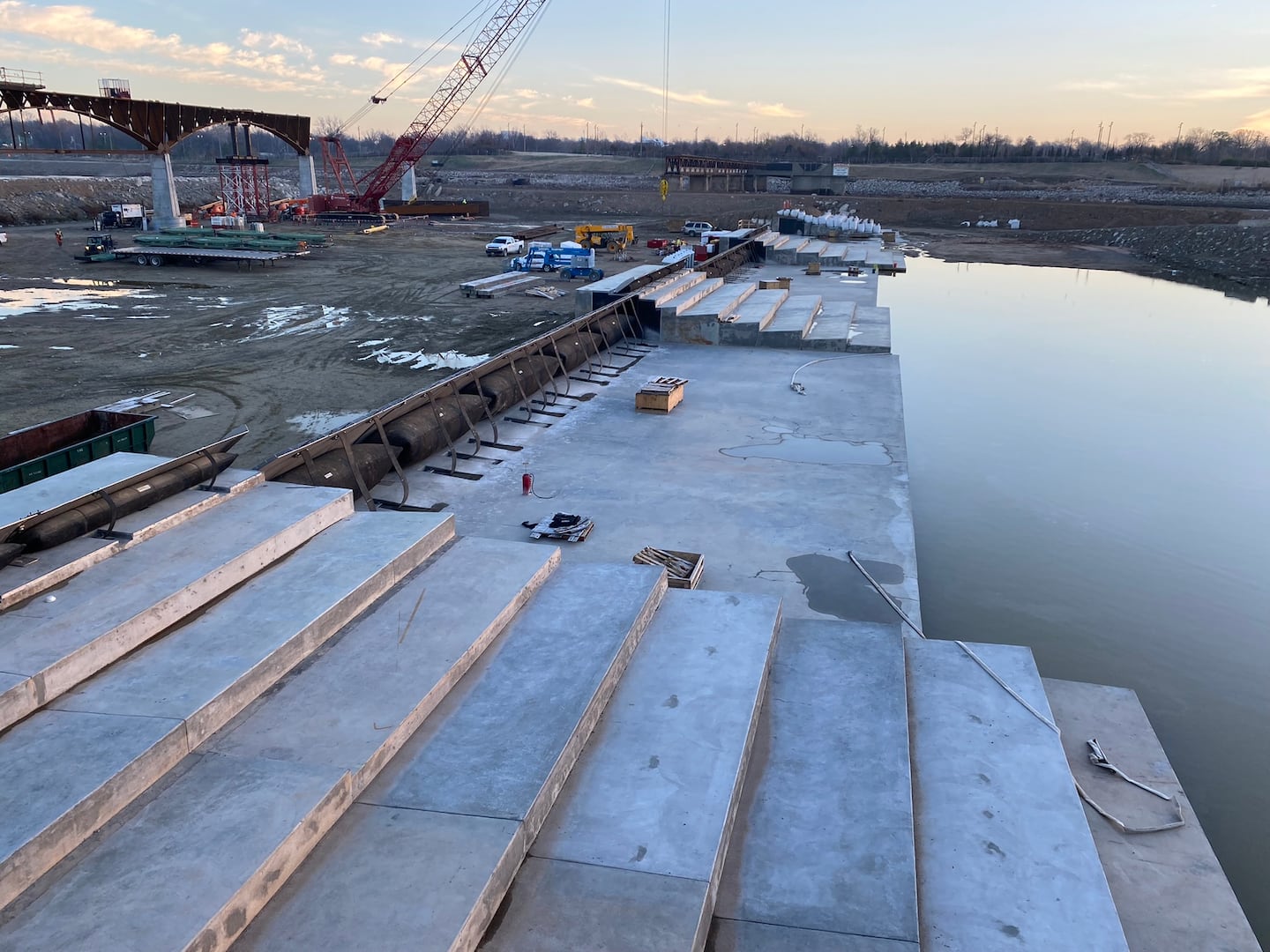 The step-like structures on the downstream side are designed to mitigate the "roller effect" which can trap swimmers or boaters